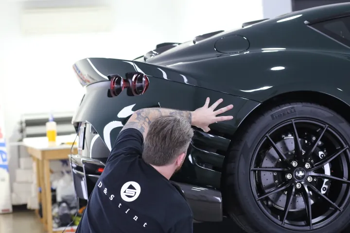 Installer working on a Ferrari rear guard