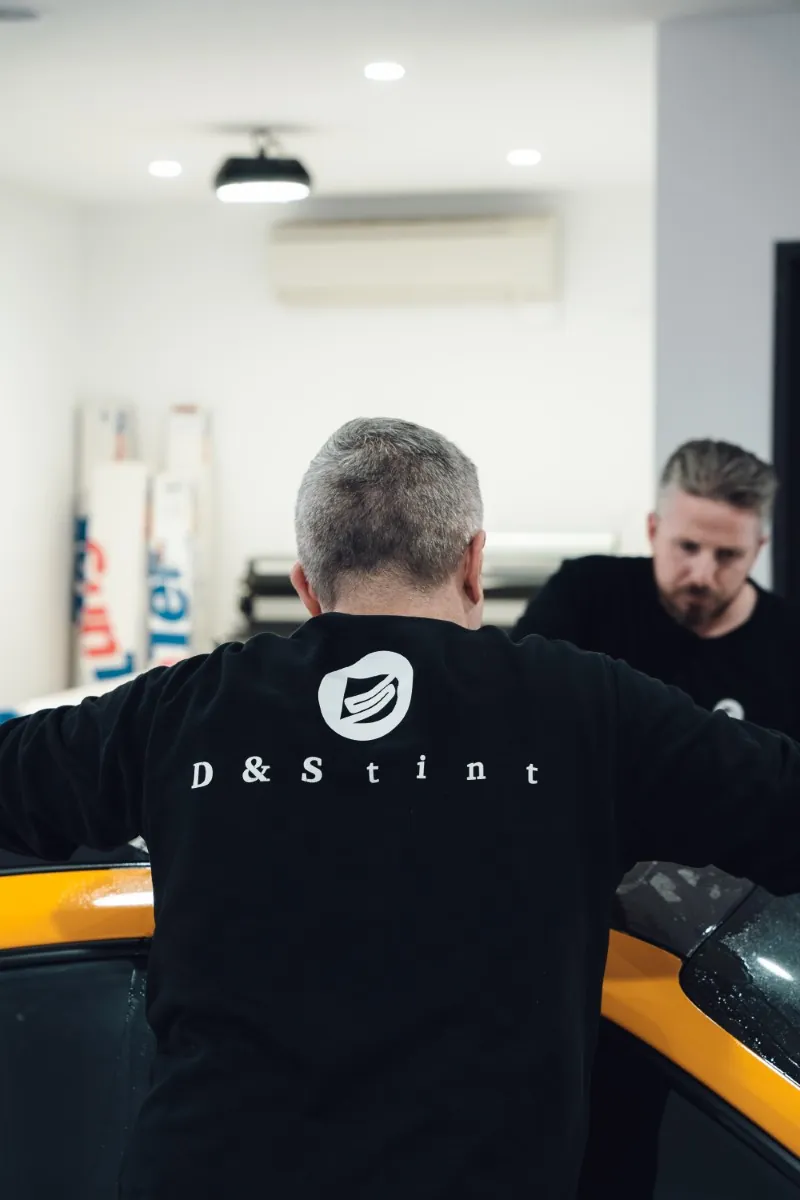 Heath and Sam from D&S Tint at work on a car in the studio