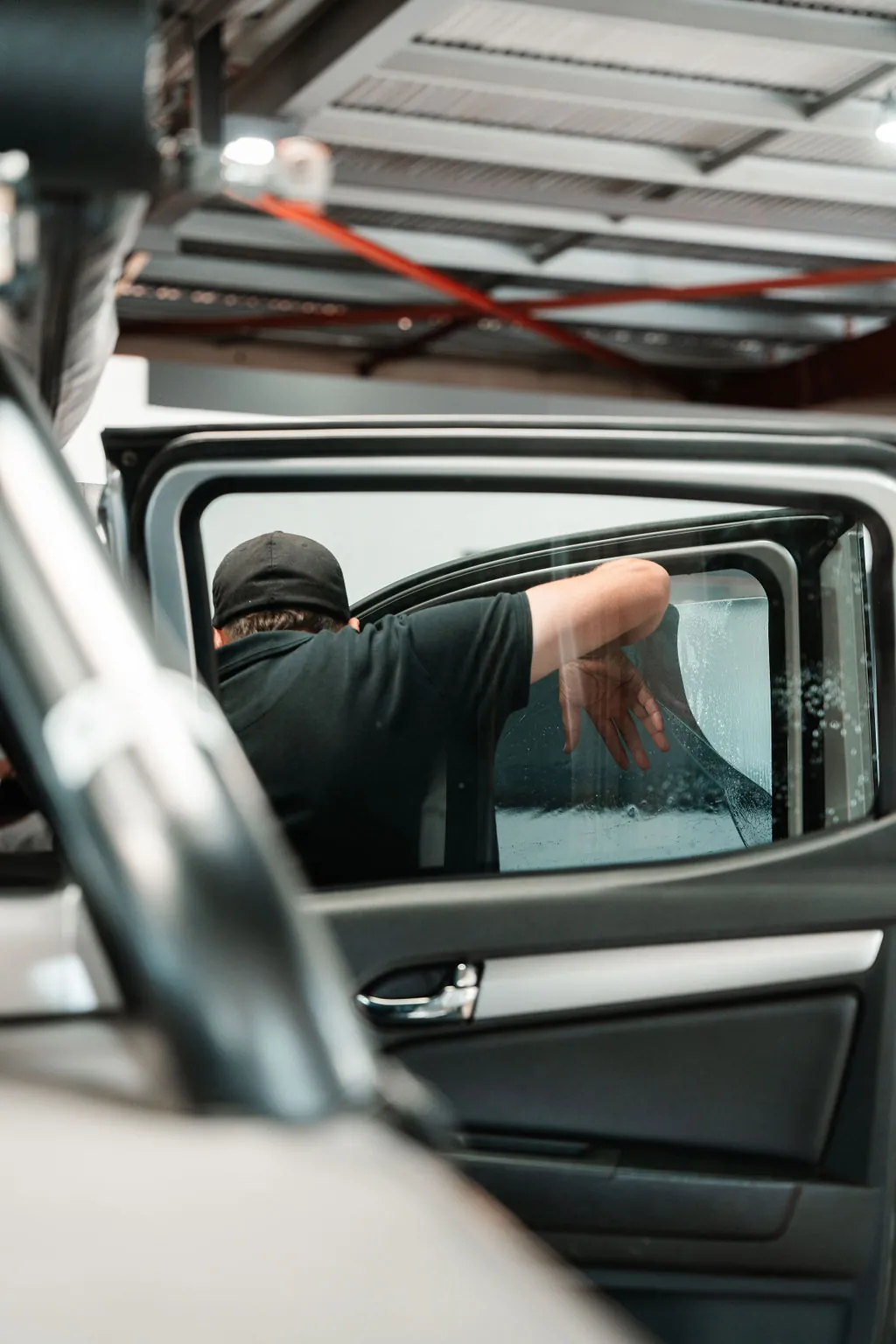 Tint being fitted to a rear door window