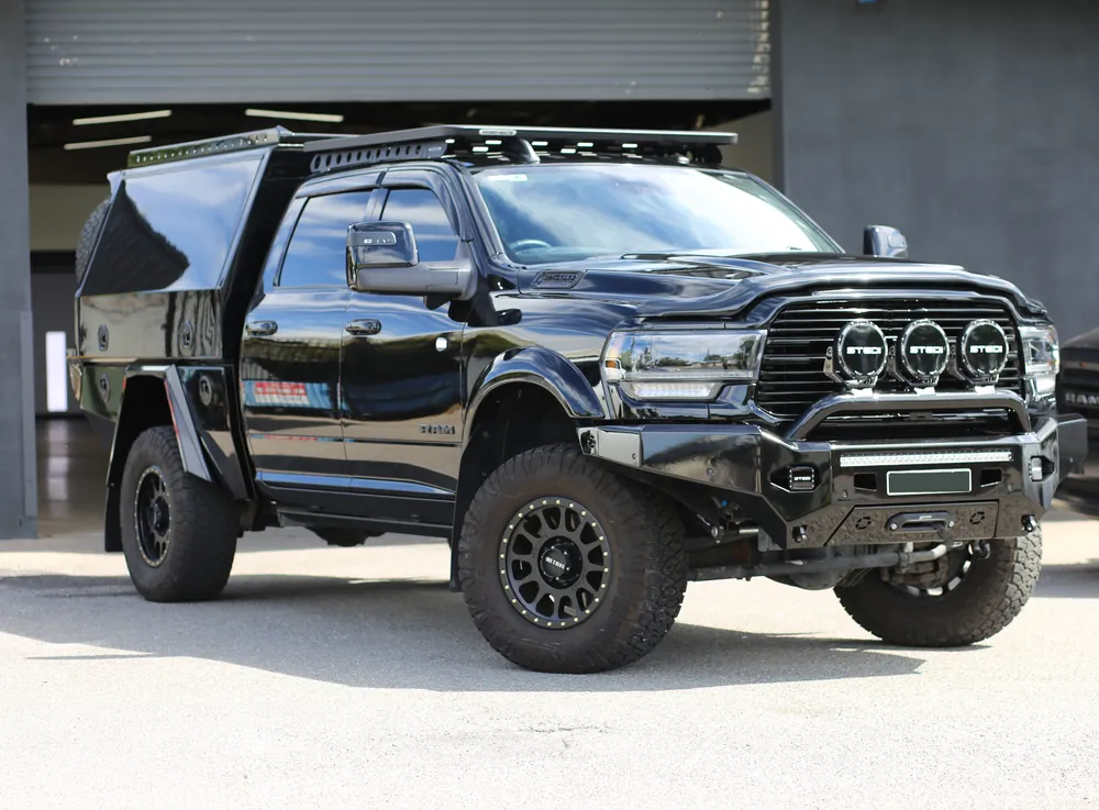 Black RAM 2500 with a canopy, roof rack and bull bar outside the D&S studio